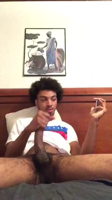 Cute young hairy black dude stroking his huge cock