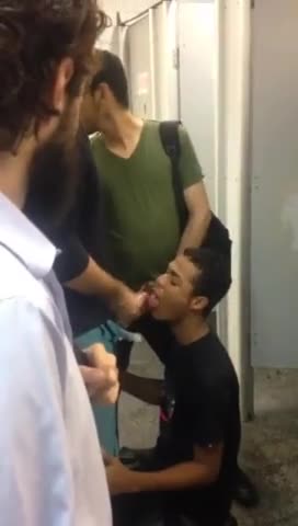 Horny sissy dude sucks a group of men's cocks in the public toilet