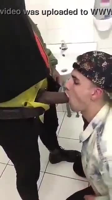 Young white boy sucks stranger black cock in public toilet